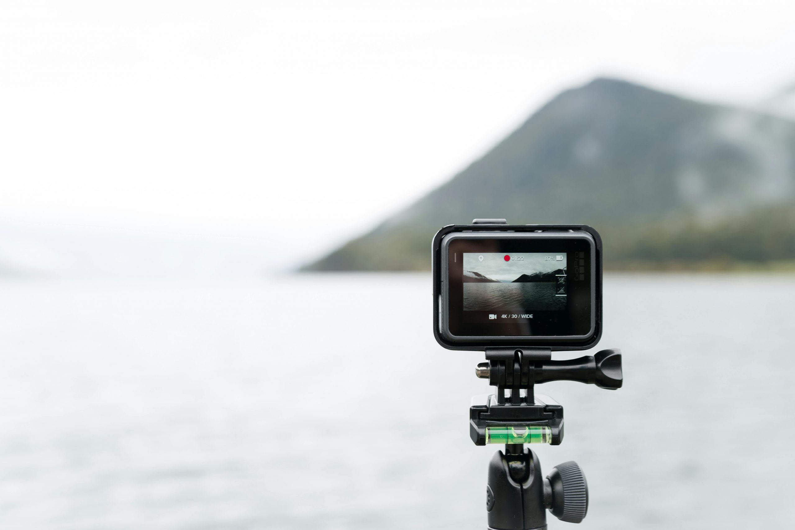 tripod-mounted gopro overlooking the sea and a distant mountain
