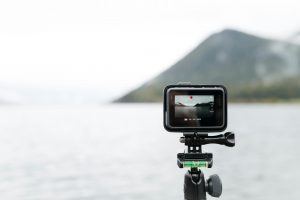 tripod-mounted gopro overlooking the sea and a distant mountain